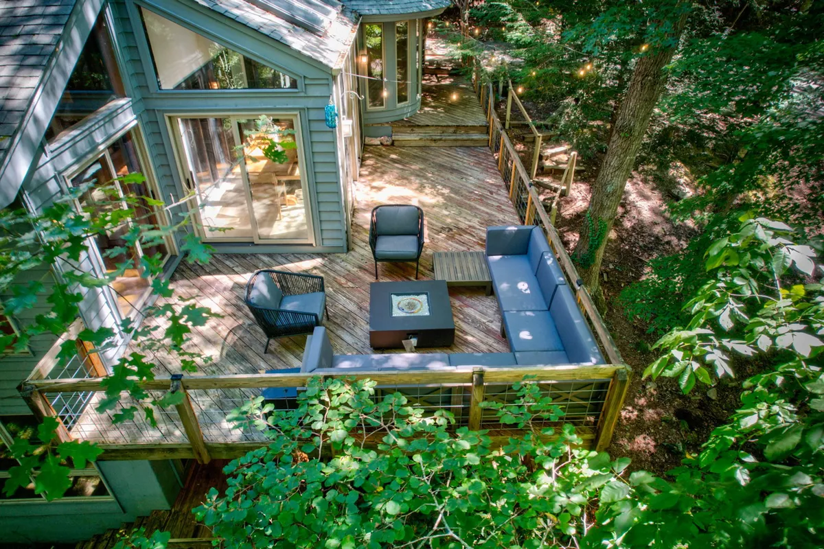 A tranquil outdoor seating area with a fire pit, surrounded by lush greenery. The setting is ideal for enjoying sunset views, socializing, or simply relaxing in the fresh mountain air with your furry friend nearby.